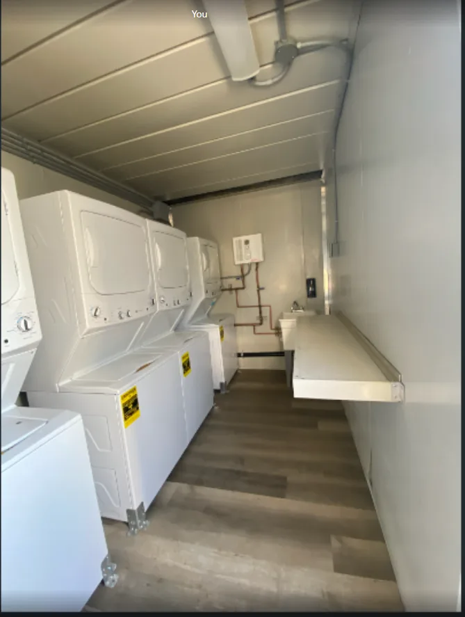 Commercial laundry equipment inside a 20-foot container